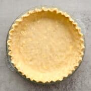Pie crust with fluted edges in a pie dish.