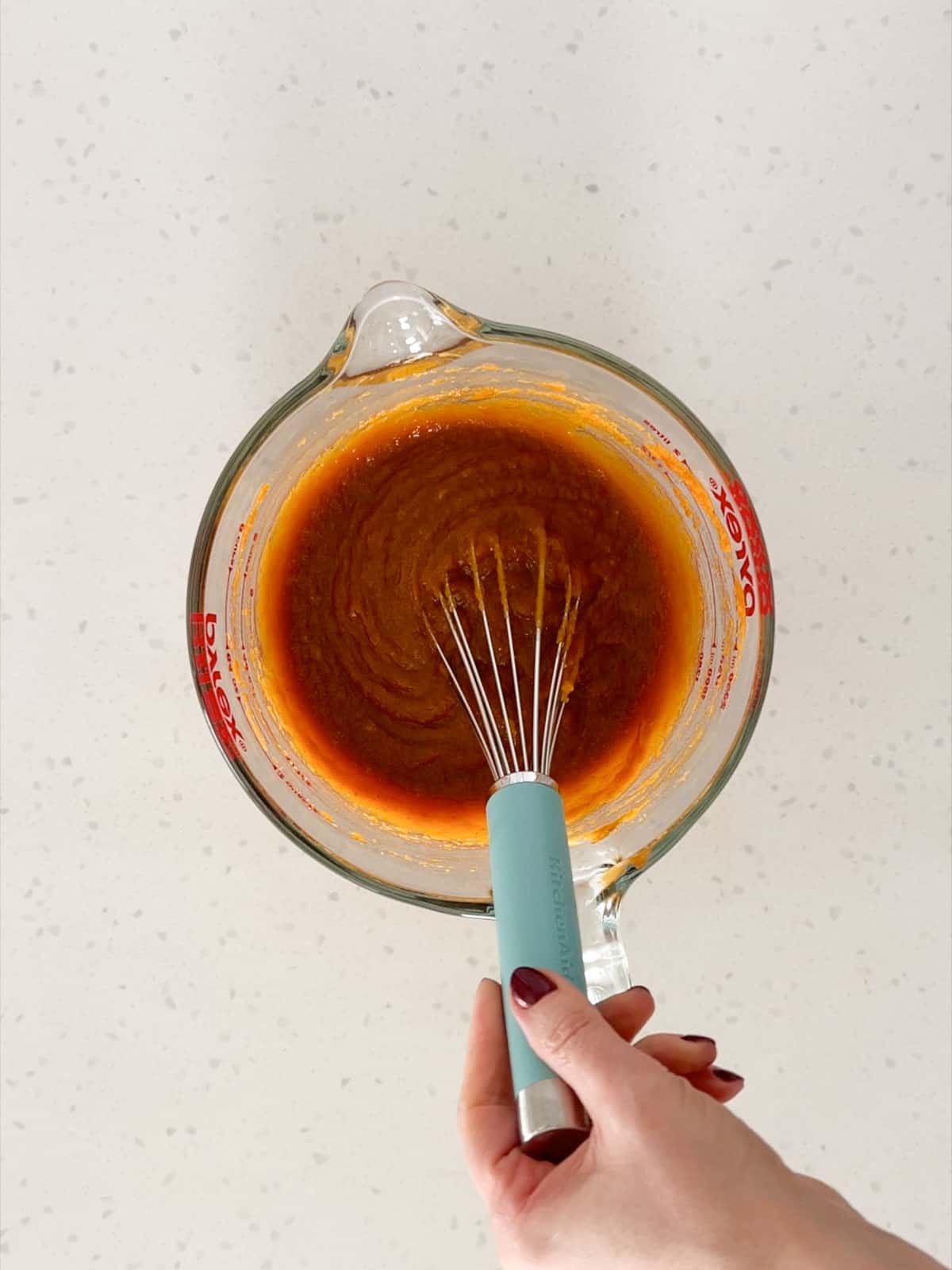 Pumpkin puree, eggs, brown sugar, and cane sugar are whisked together.