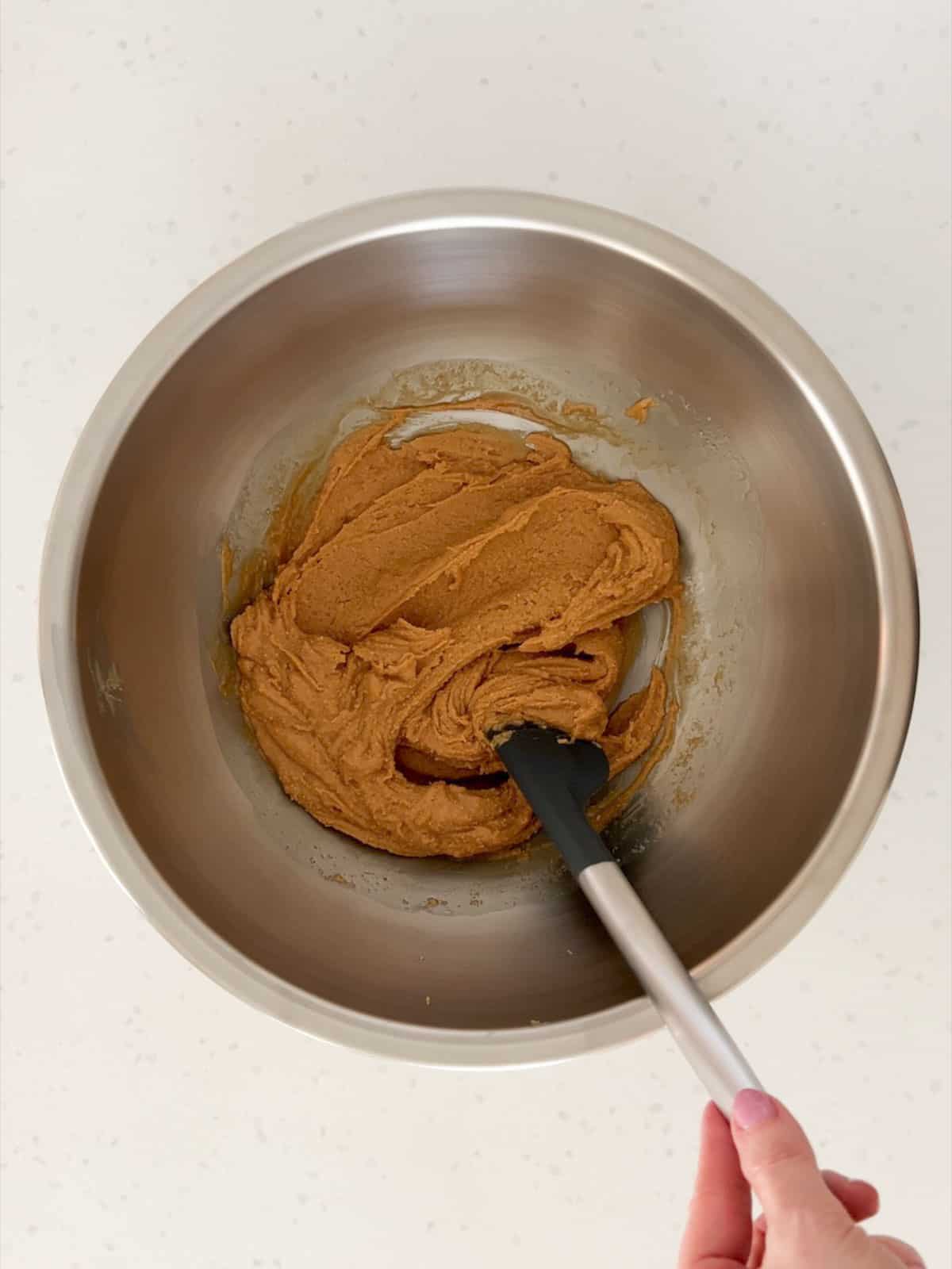 Peanut butter and maple syrup mixed together in a bowl.