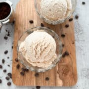 Two bowls of espresso ice cream on a wooden serving tray.