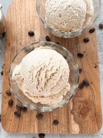 Two bowls of espresso ice cream on a wooden serving tray.
