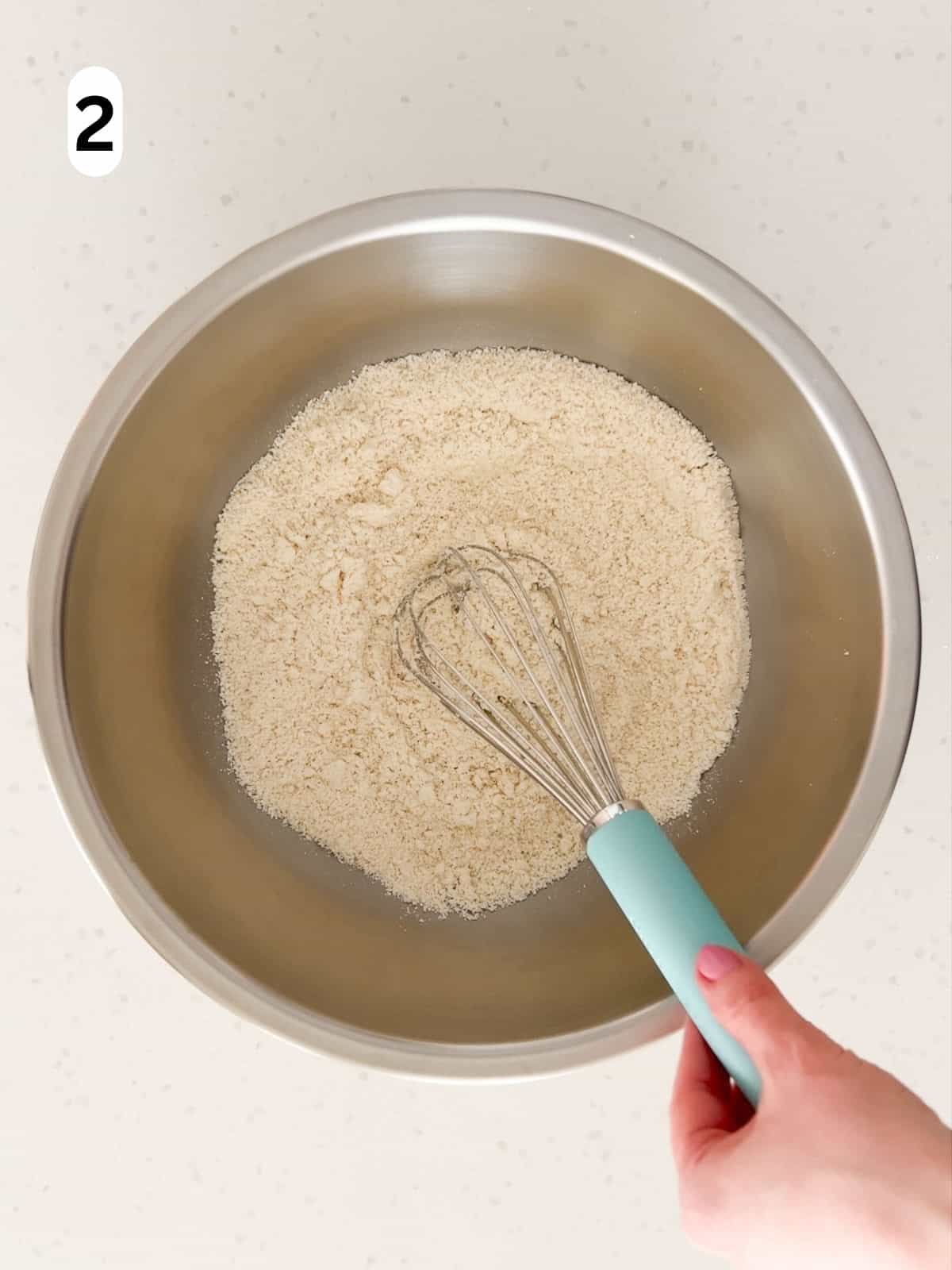 Almond flour, all purpose flour, baking powder, and salt are whisked together.