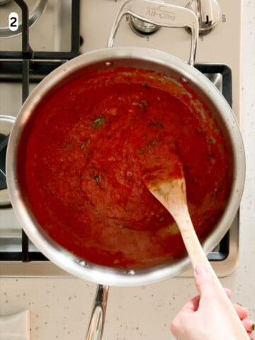 Fresh chopped basil is mixed into the thickened sauce.