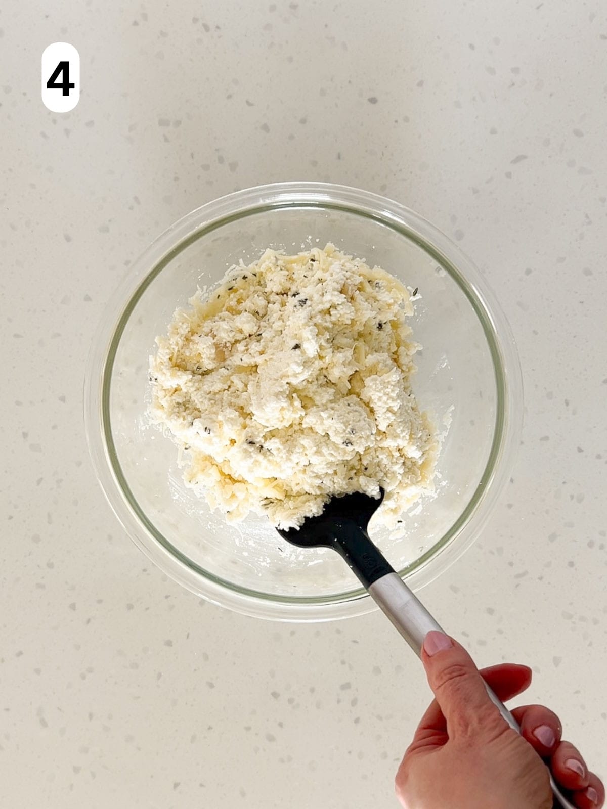 Ricotta, parmesan, mozzarella, and thyme are mixed together.