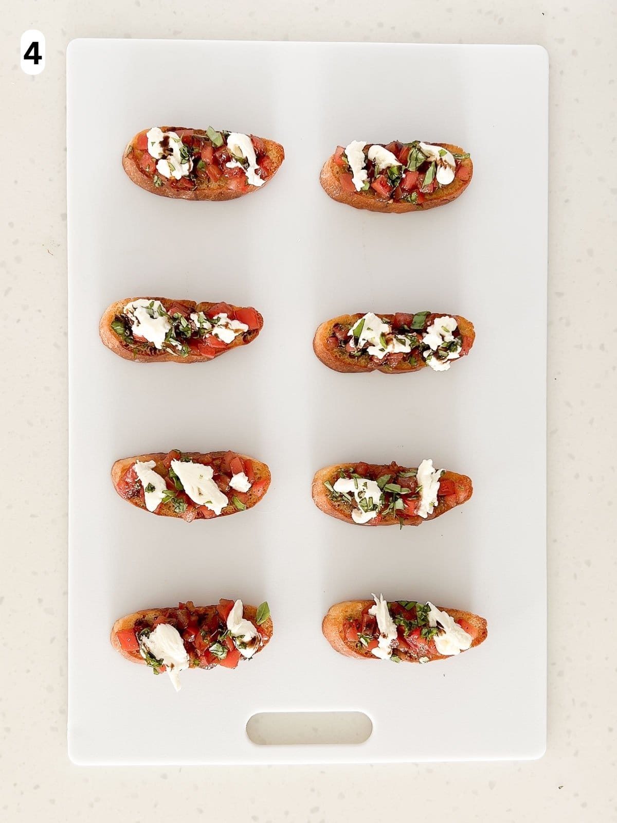 The bruschetta is topped with burrata.