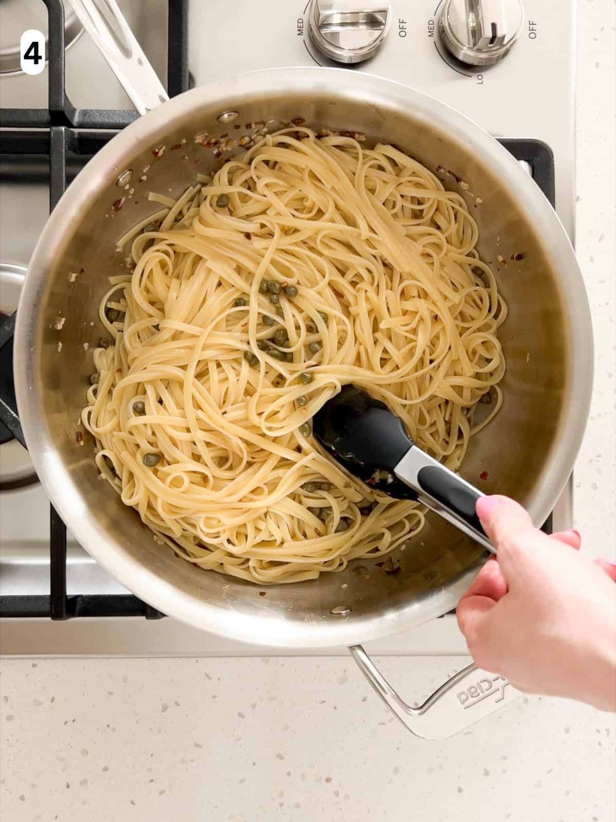 The pasta and sauce are tossed together until combined.