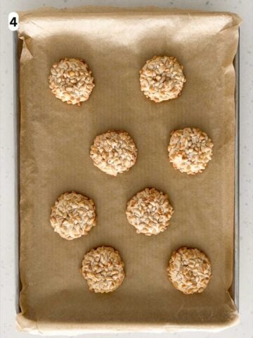 The pignoli cookies are baked until lightly golden and the pine nuts are toasted.