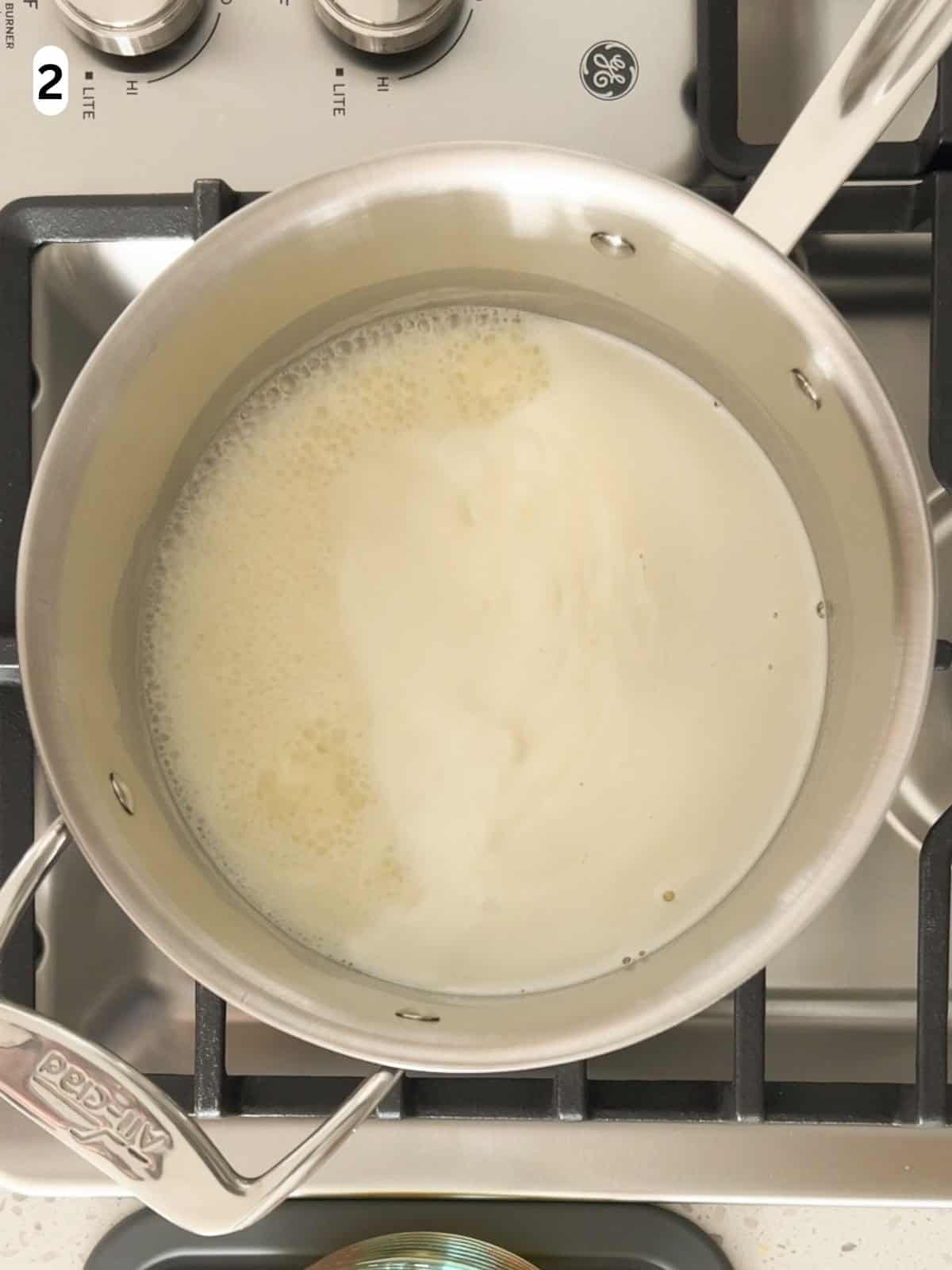 The milk, cream, and sugar are brought to a simmer.
