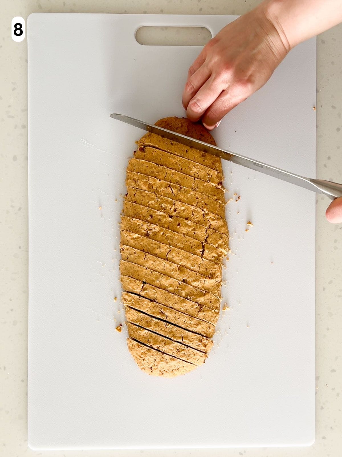 The biscotti is sliced diagonally into half-inch slices.