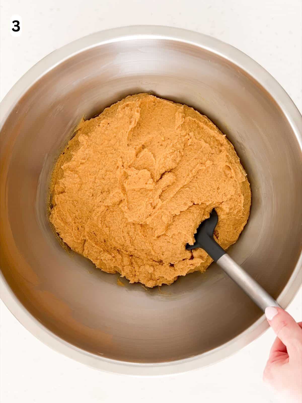 The mascarpone cream is folded into the pumpkin mixture until combined.