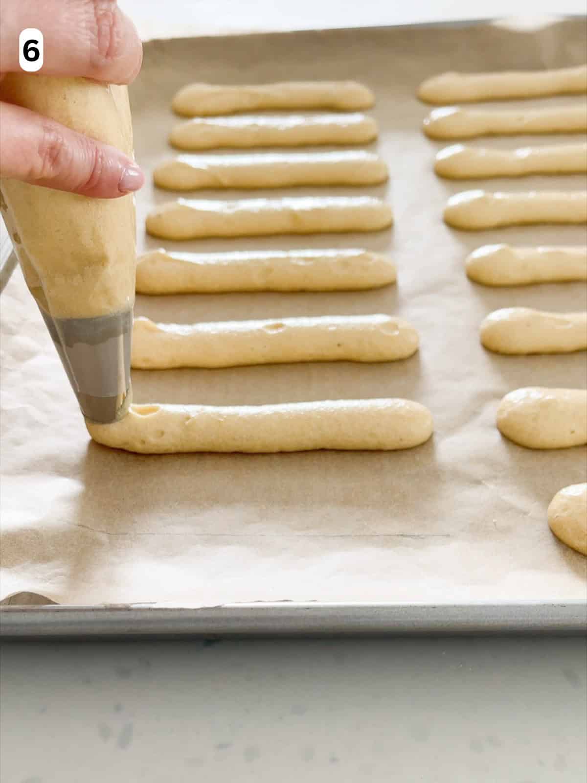 The batter is piped into even strips.