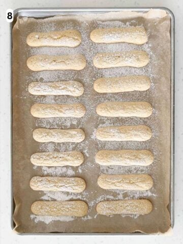 The savoiardi (ladyfingers) are baked until firm and the edges are lightly golden.