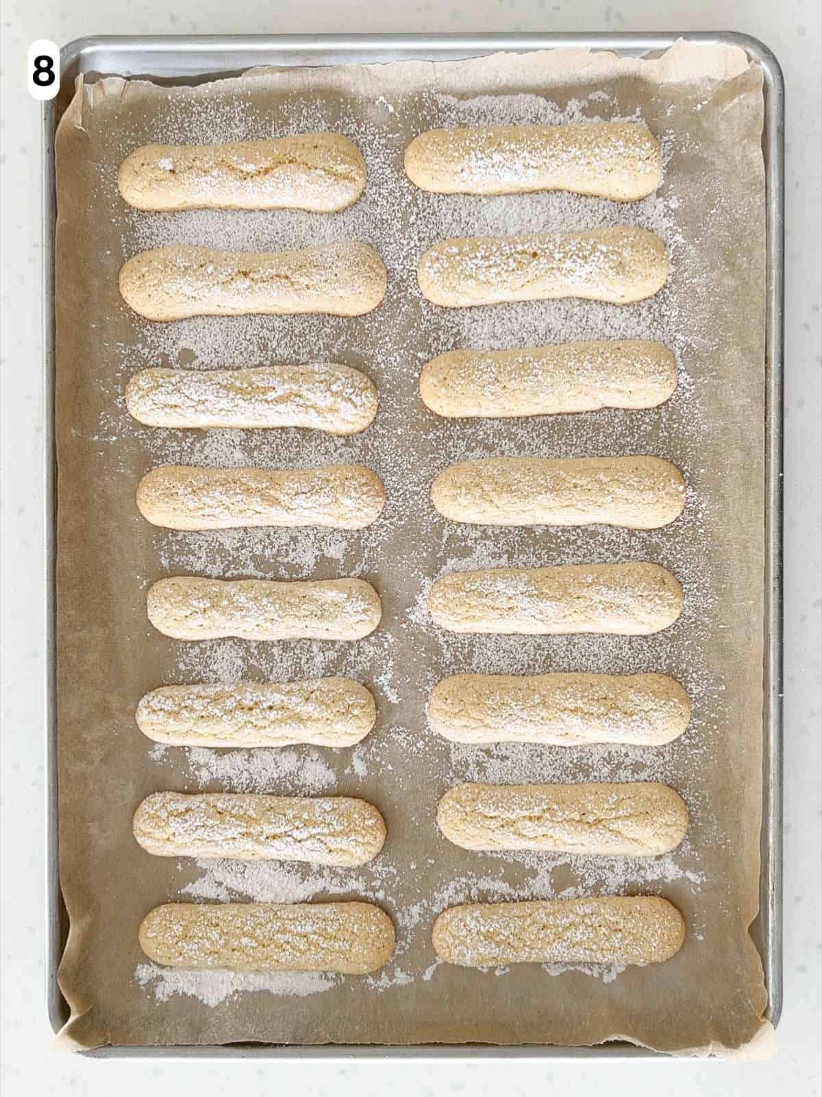 The savoiardi (ladyfingers) are baked until lightly golden.