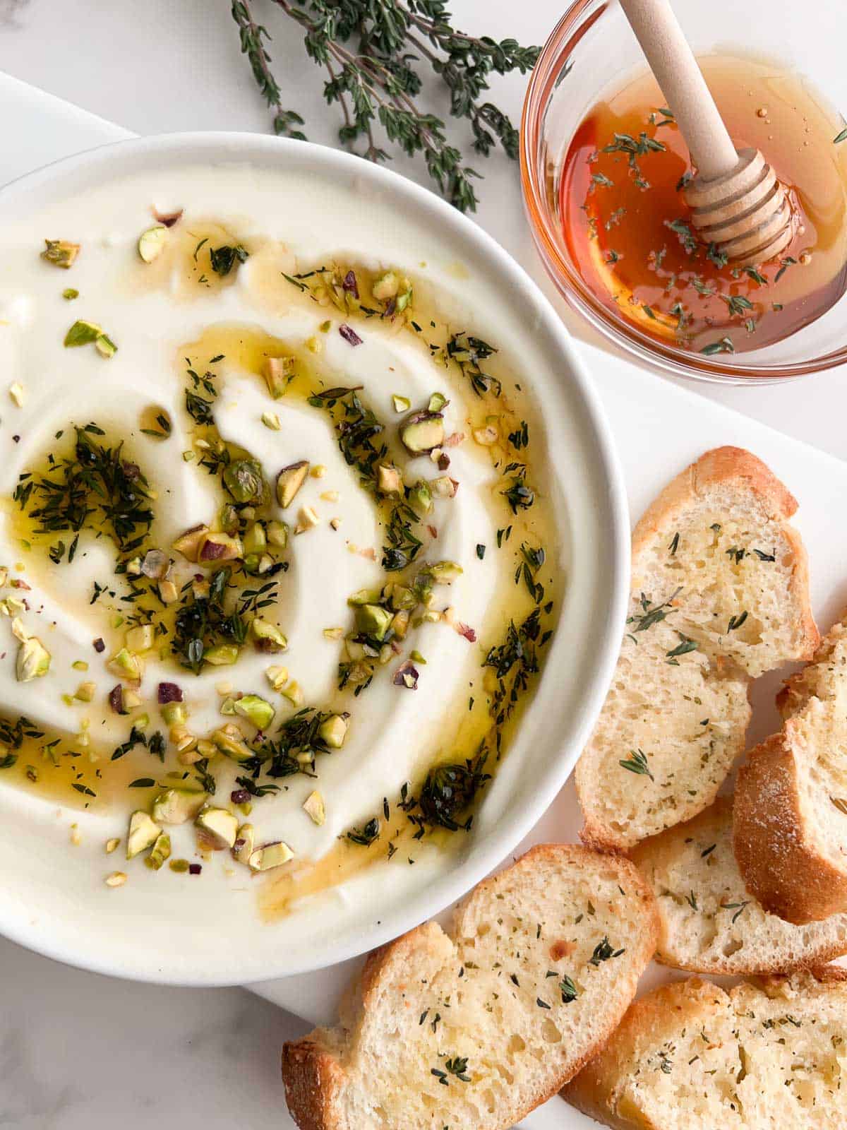 A bowl of whipped ricotta dip served with toasted bread.