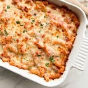 Baked ziti with sausage in a baking dish.