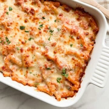 Baked ziti with sausage in a baking dish.