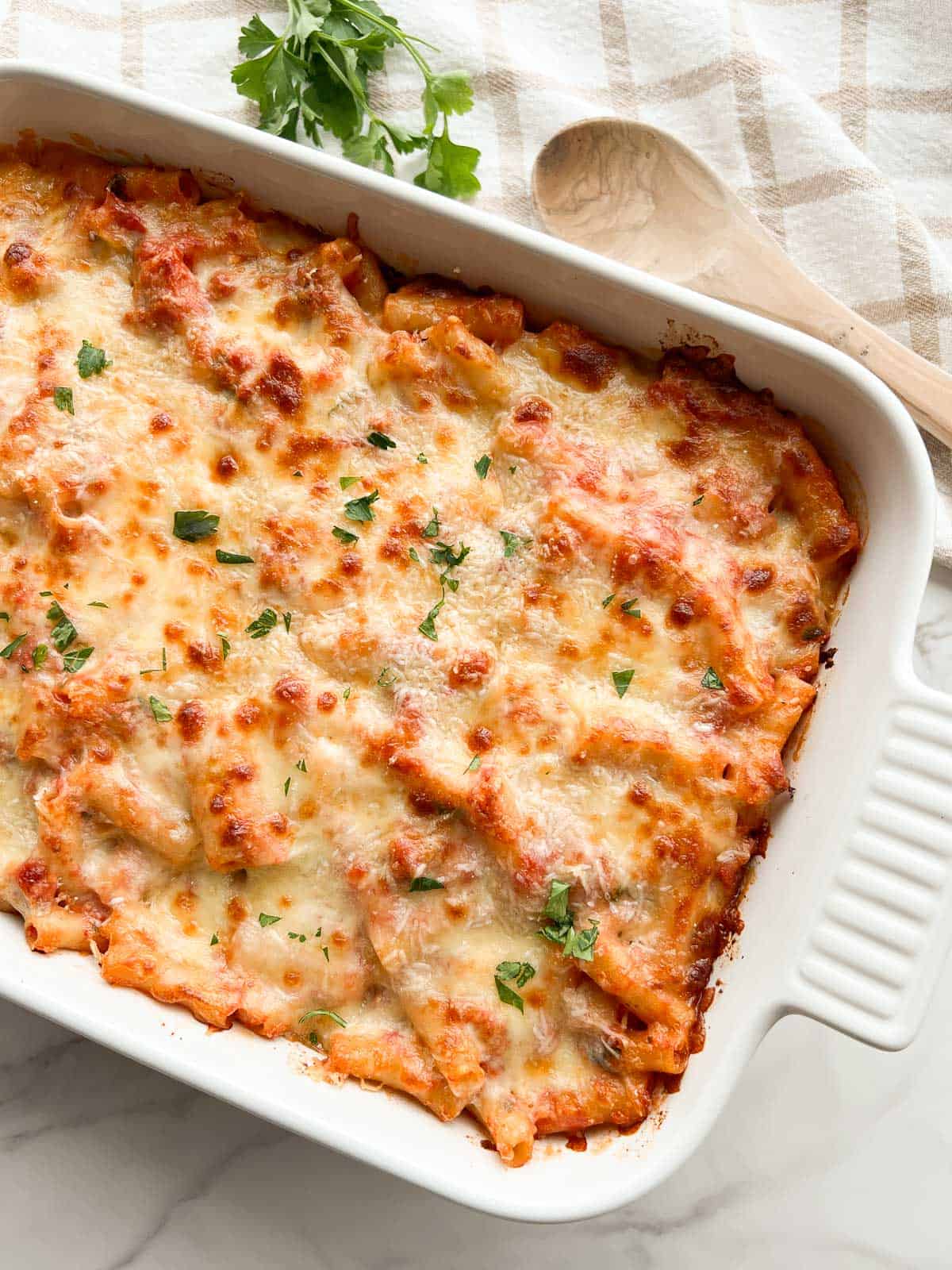 Baked ziti with sausage in a baking dish.