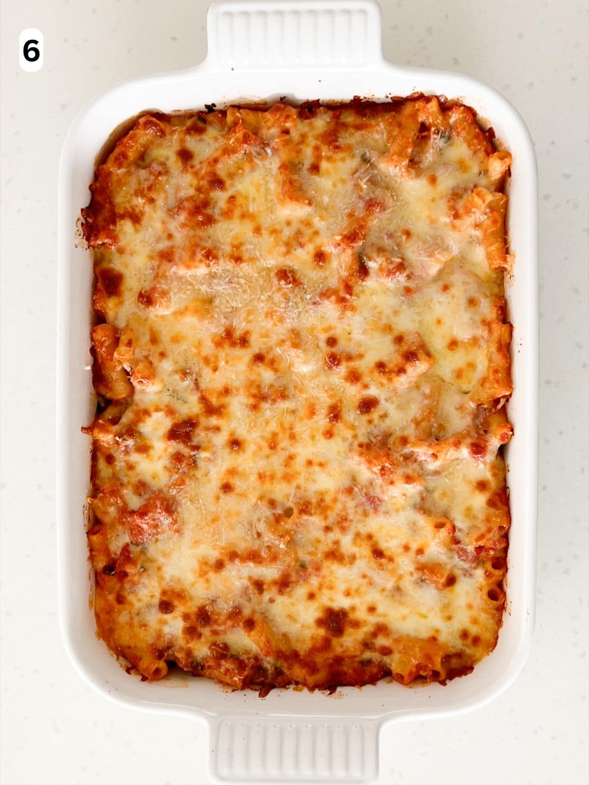 The baked ziti is baked until the sauce is bubbling and the cheese topping is golden.