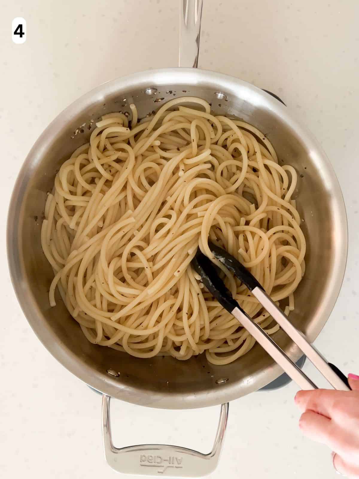 The pasta is tossed in the pepper sauce.