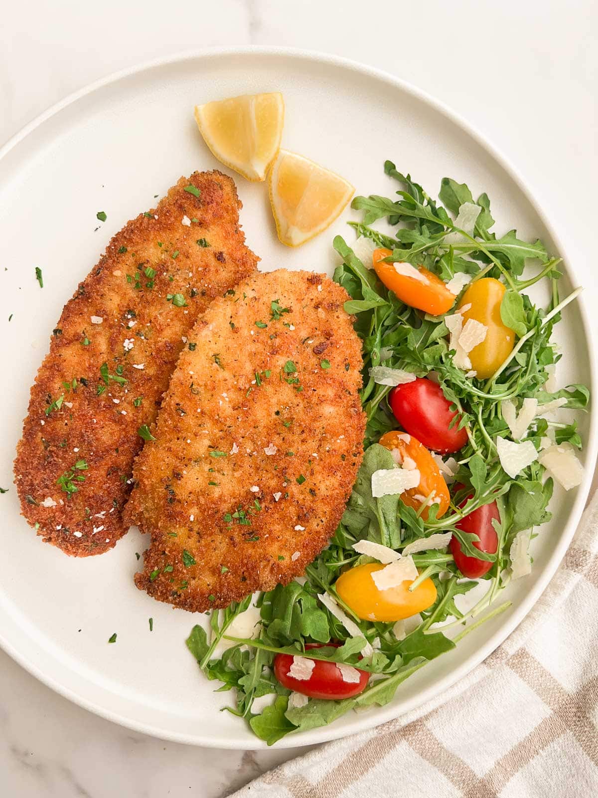 Chicken Milanese with an arugula salad to the side.