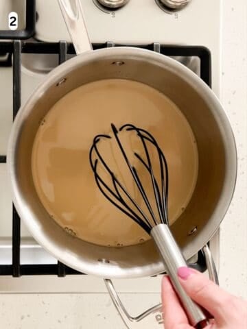 The panna cotta ingredients are whisked as they warm in a saucepan.
