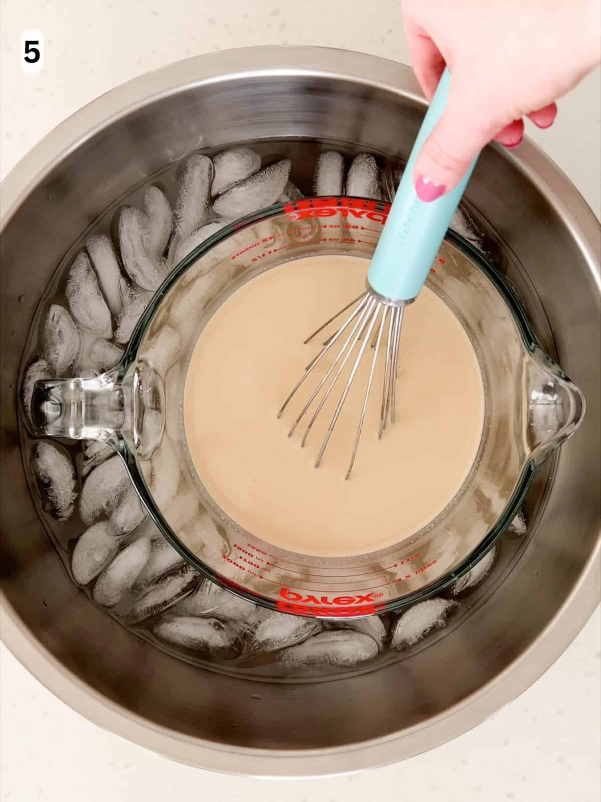 The panna cotta is whisked as it cools in an ice bath.