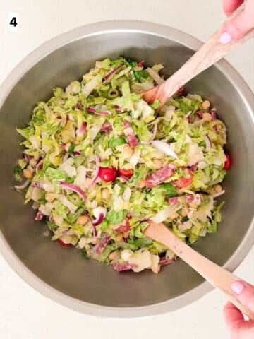 The salad ingredients are tossed together.
