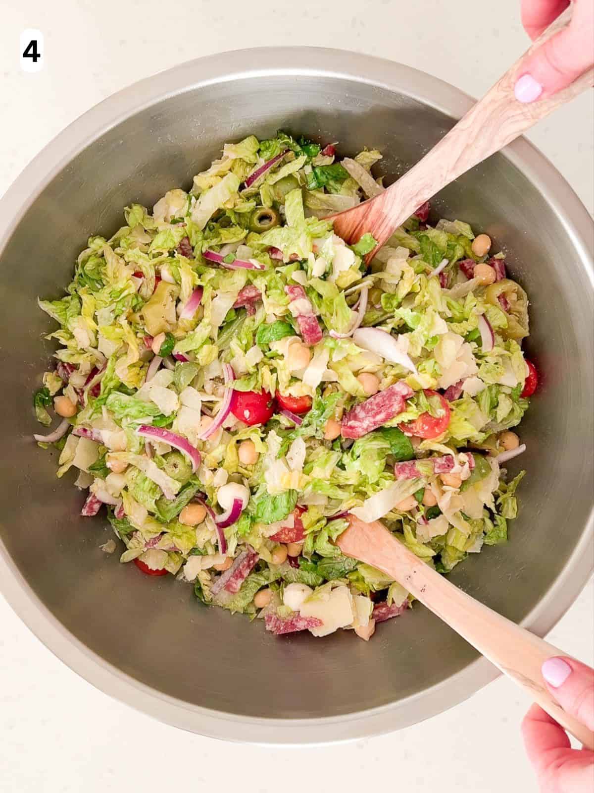 The salad ingredients are tossed together.