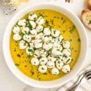 A bowl of marinated mozzarella balls.