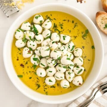 A bowl of marinated mozzarella balls.