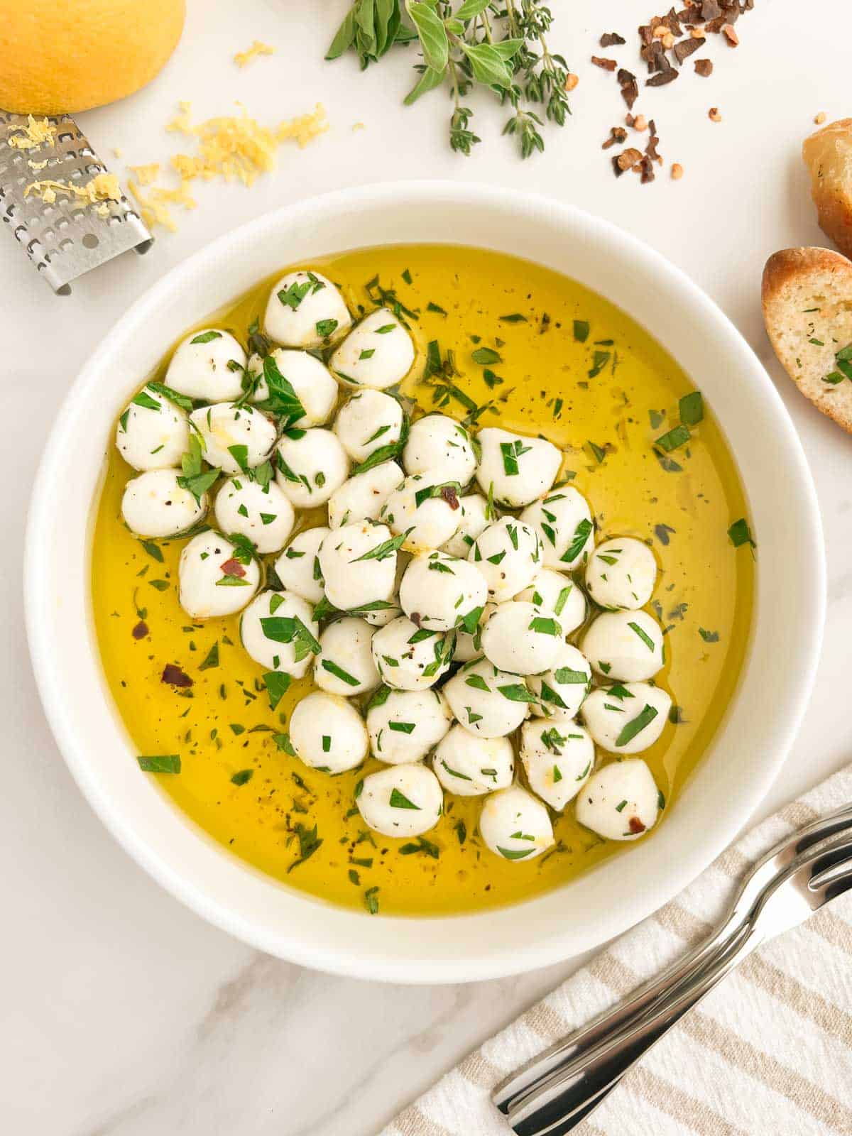 A bowl of marinated mozzarella balls.