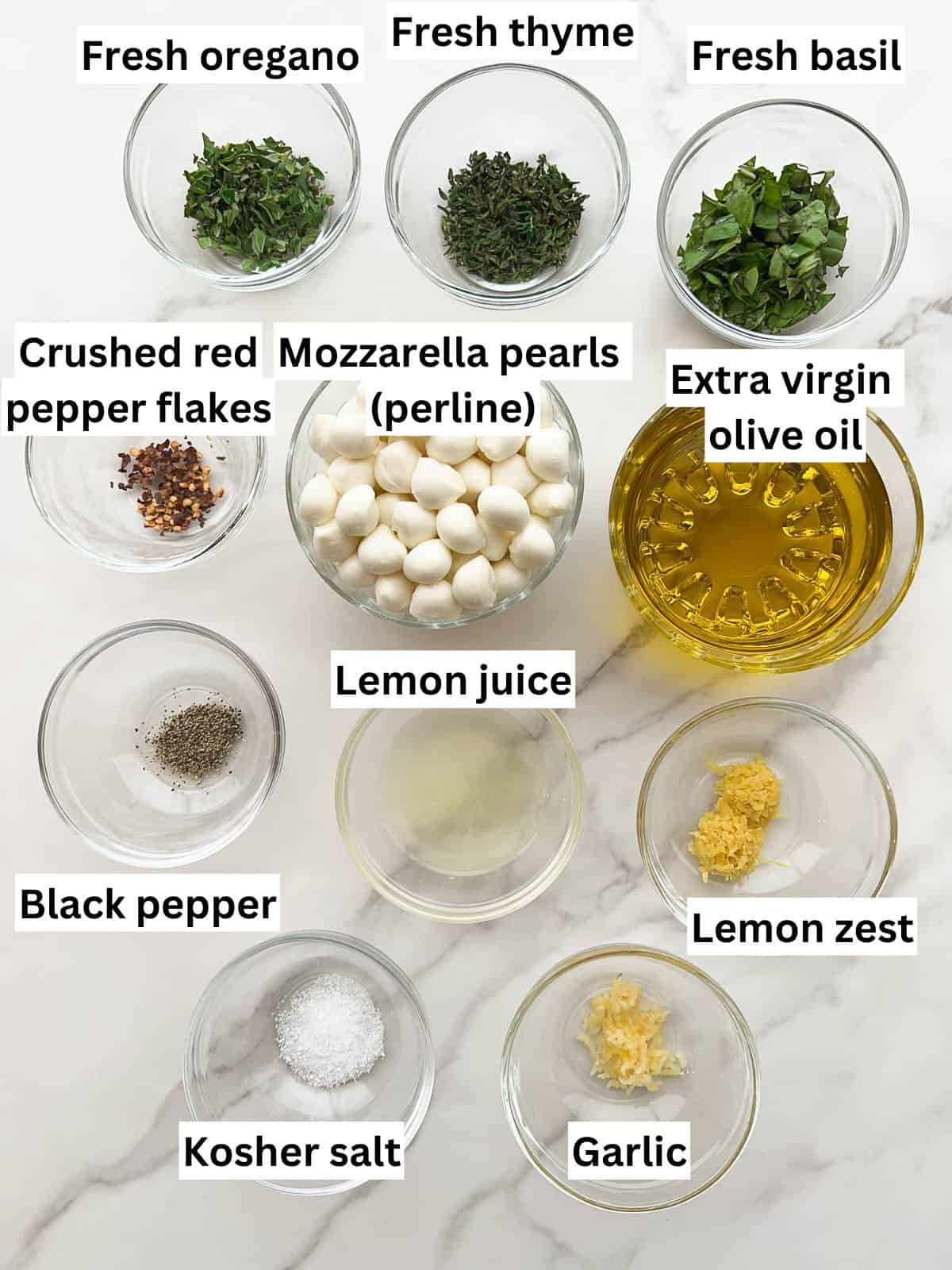 The ingredients to make marinated mozzarella balls.