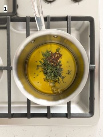 Olive oil gently infused with garlic, thyme, oregano, and red pepper flakes over low heat.