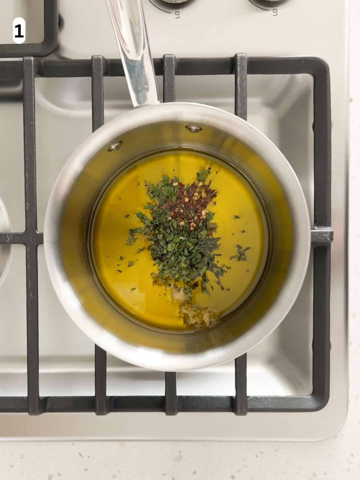 Olive oil gently infused with garlic, thyme, oregano, and red pepper flakes over low heat.