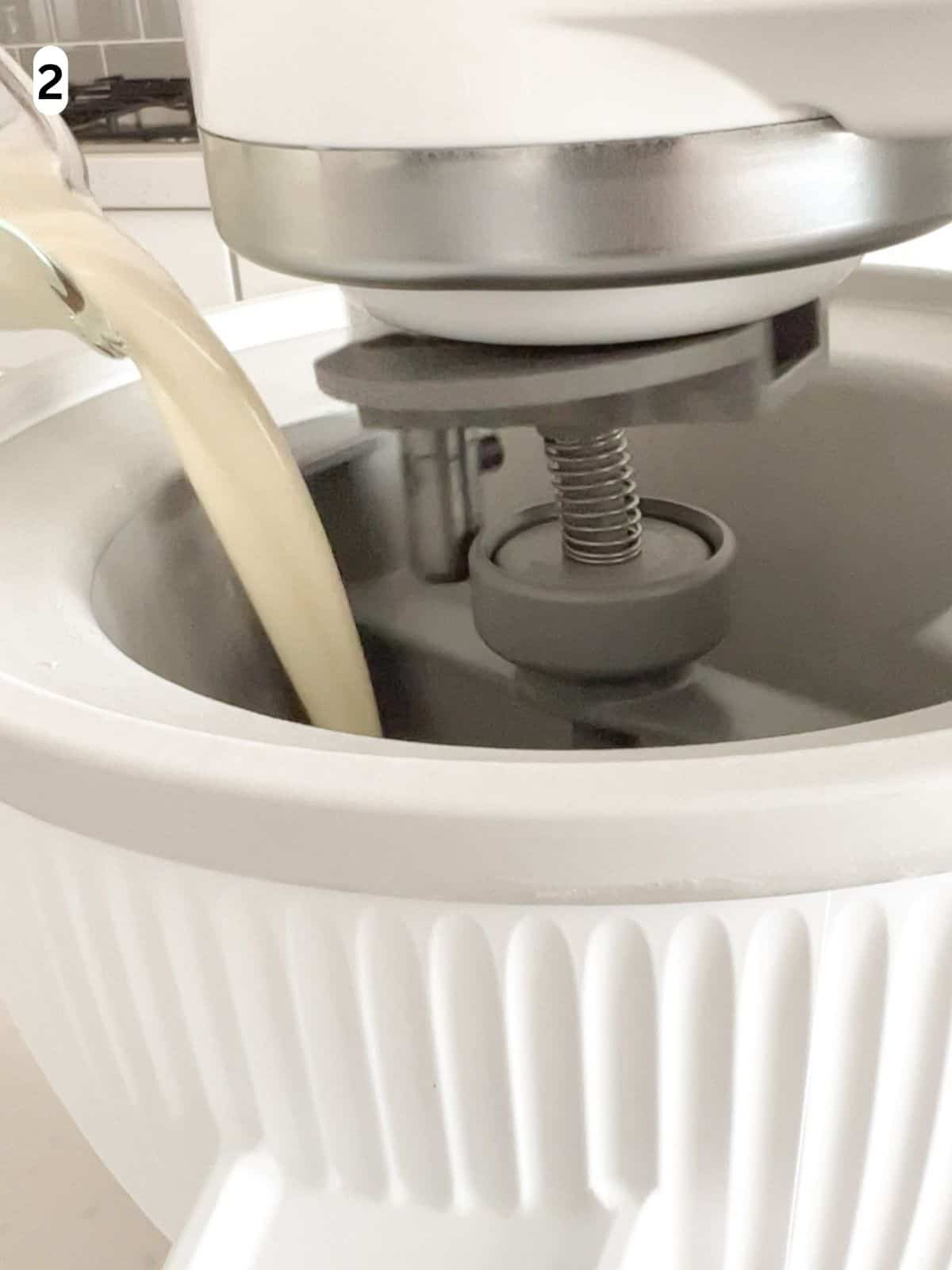 The vanilla ice cream mixture is poured into an ice cream maker.