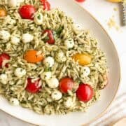 Orzo pesto pasta salad on a serving platter.