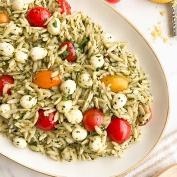 Orzo pesto pasta salad on a serving platter.