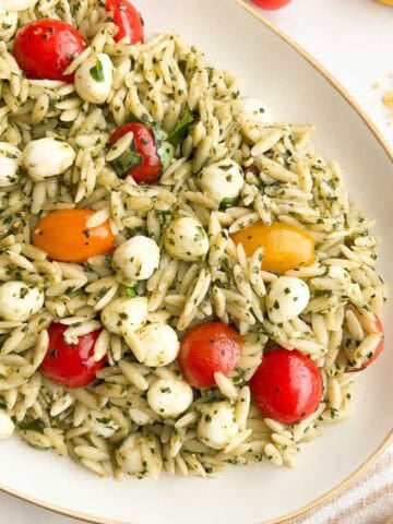 Orzo pesto pasta salad on a serving platter.