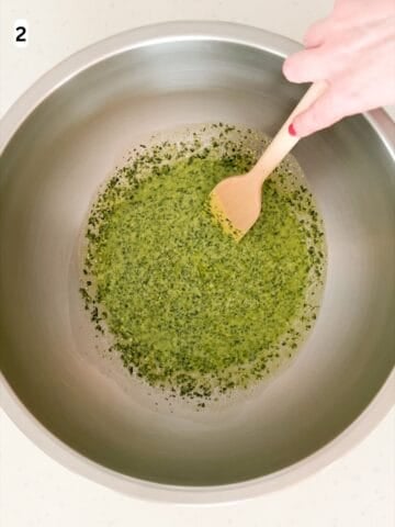 Pesto is mixed with pasta water until combined.